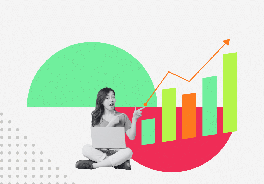 Excited woman with laptop pointing at a rising trend graph with bright bars, symbolizing the growth and success detailed in the Iowa 2023 Design and Cost State Report by 1706 Advisors.